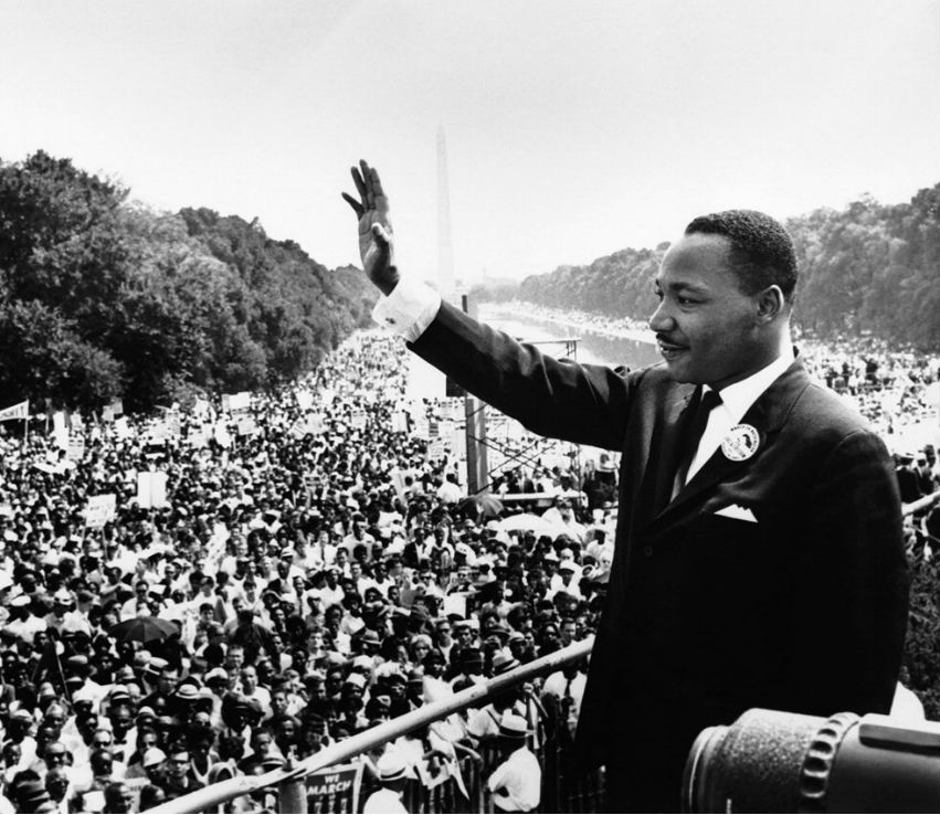 Martin Luther King Jr waving to crowd during 